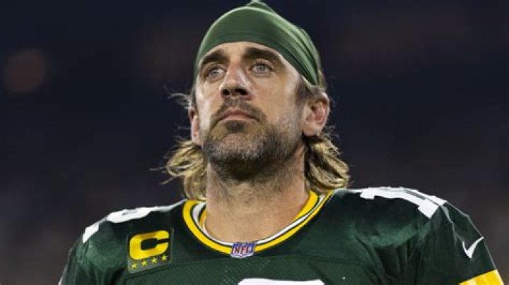 Why does Aaron Rodgers grow her hair?